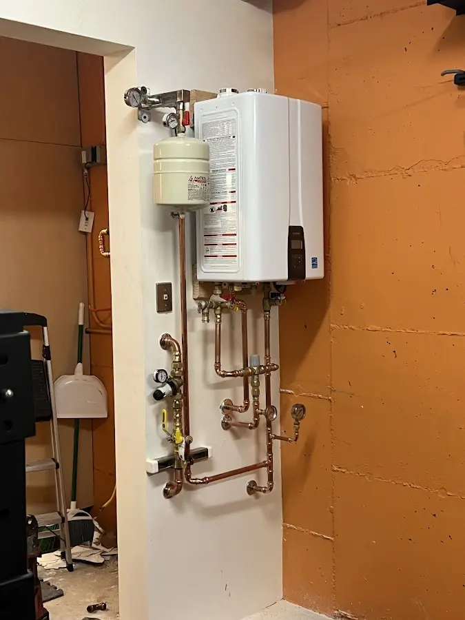 Plumbing technician inspecting water heater connections in McKinleyville